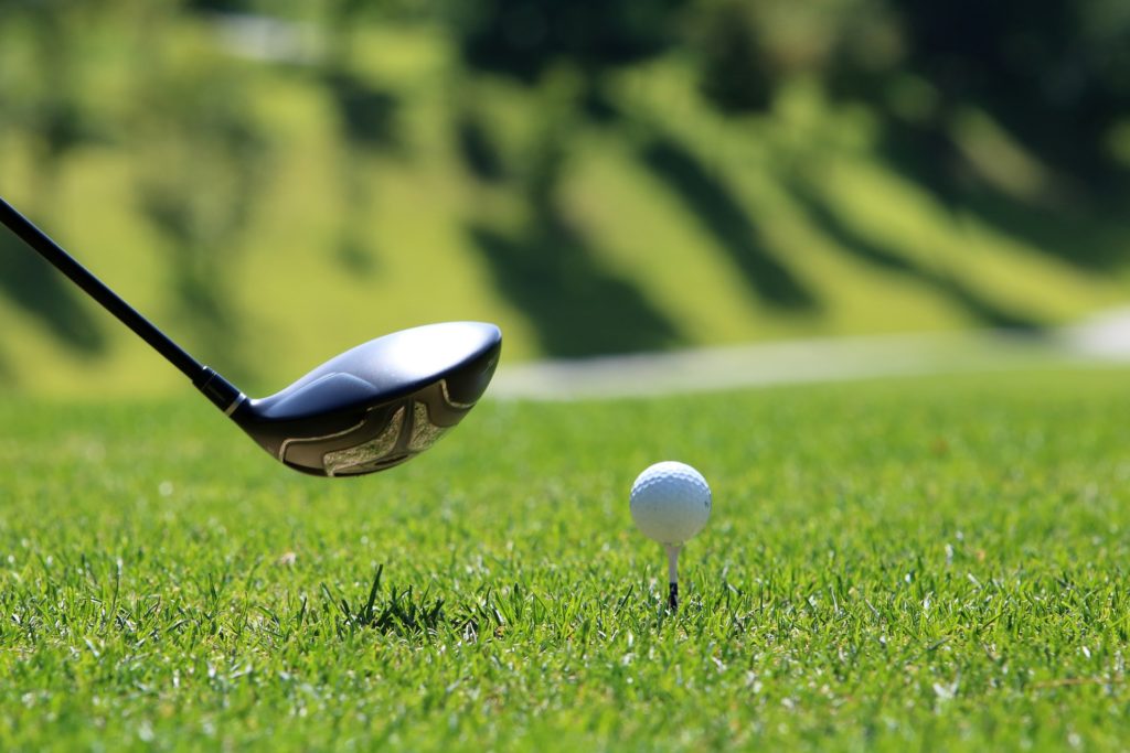 driving club and golf ball on a tee