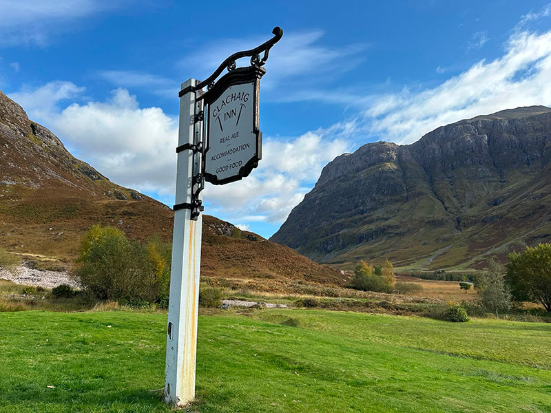 clachaig inn sign in scotland with mountains